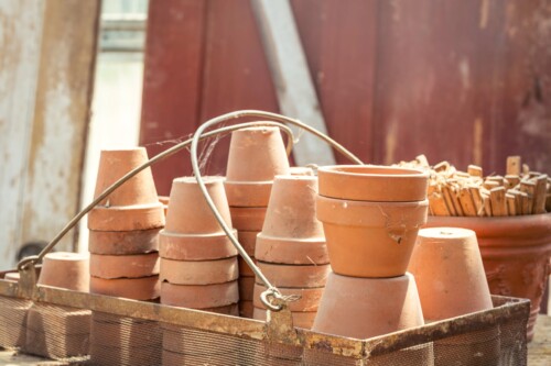 Terracotta Flower Pots Stacked on a Garden Potting Bench