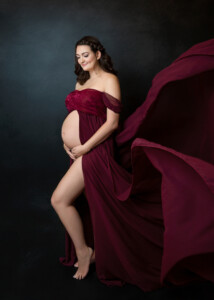 Glamourous Studio Portrait of a Beautiful Pregnant Woman Styled in a Beautiful Gown