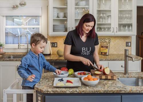 Mother and Toddler Preparing Food Together in the Kitchen