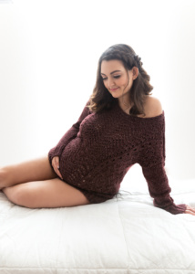 Intimate Studio Portrait of a Beautiful Pregnant Woman Posed in Bed